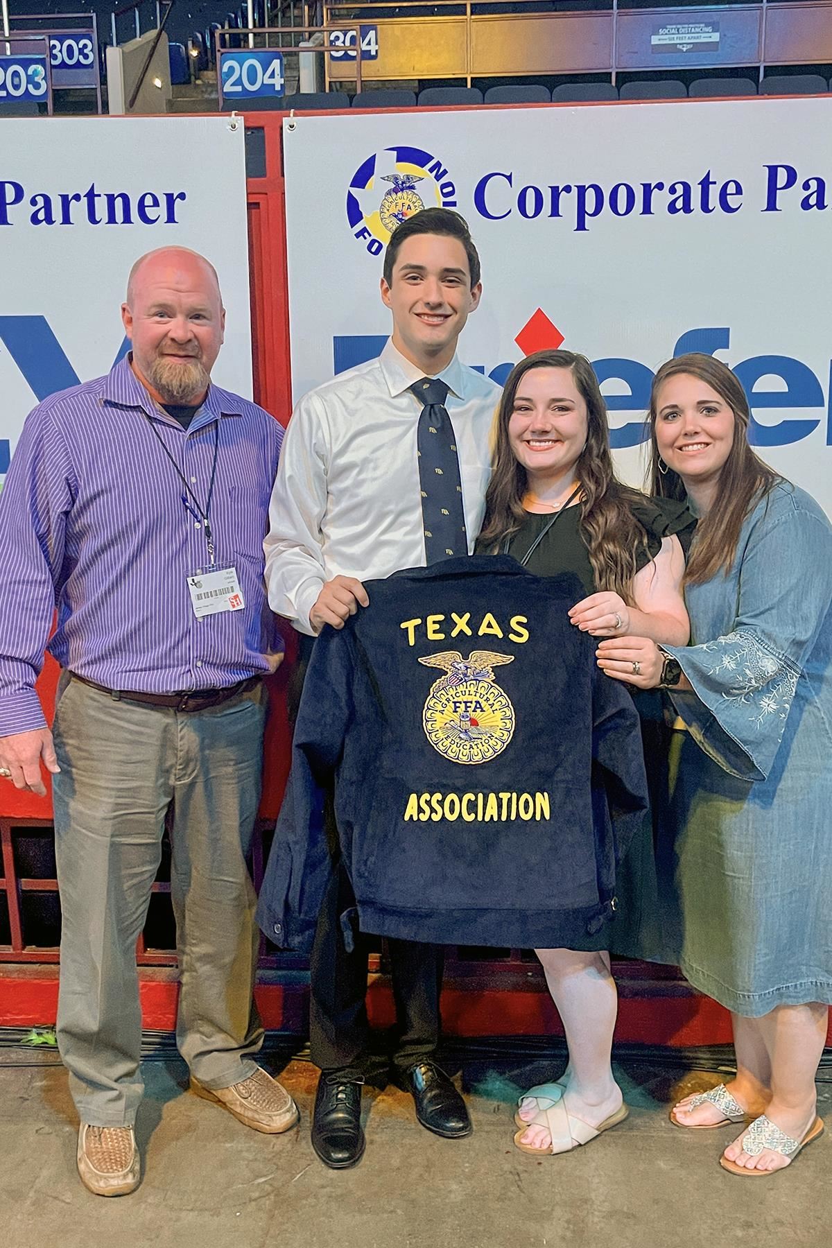 Jersey Village graduate Logan Jaure, second from left, poses with Jersey Village FFA advisers.